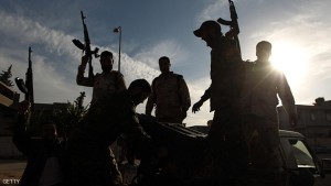 Members of a brigade headed by field commander Salah Bogheib and loyal to Khalifa Haftar -a retired general and former chief of staff for Moamer Kadhafi- hold up their guns as they fight alongside Libyan army troops against Islamist gunmen in the eastern Libyan city of Benghazi on December 17, 2014. Battles between the coalition of the army and forces loyal to Haftar against militia gunmen took place in several parts of the city but the army reportedly secured the area south-west of the city centre. AFP PHOTO / ABDULLAH DOMA (Photo credit should read ABDULLAH DOMA/AFP/Getty Images)