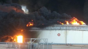 Firefighters battled a blaze at an oil facility in northern Libya for a second day running, an official said, following an attempt by jihadists to seize key export terminals. Fighting broke out a day earlier in the Ras Lanouf region, which along with the nearby Al-Sidra facility is one of the country's main oil export hubs, said the National Oil Corporation (NOC). / AFP / STRINGER (Photo credit should read STRINGER/AFP/Getty Images)