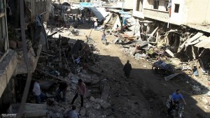Men inspect damaged shops after an airstrike on a market in the town of Maarat al-Numan in the insurgent stronghold of Idlib province
