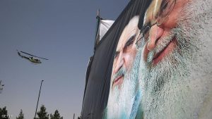 TEHRAN, IRAN - JUNE 04:  An Iranian police helicopter passes above portraits of Iran's supreme leader Ayatollah Ali Khamenei (R) and the former Ayatollah Khomeini outside Khomeini's shrine on the 25th anniversary of his death on June 4, 2014 on the outskirts of Tehran, Iran. Khomeini, the founder of the Islamic Republic, is still revered by many Iranians, and his portrait hangs throughout the country.  (Photo by John Moore/Getty Images)