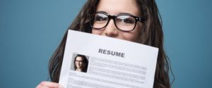 Young woman holding her resume